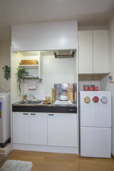 キッチン（Aタイプ）　コンロとシンクの間にまな板が置けるスペースがあります。※モデルルームの写真です。小物はございません。